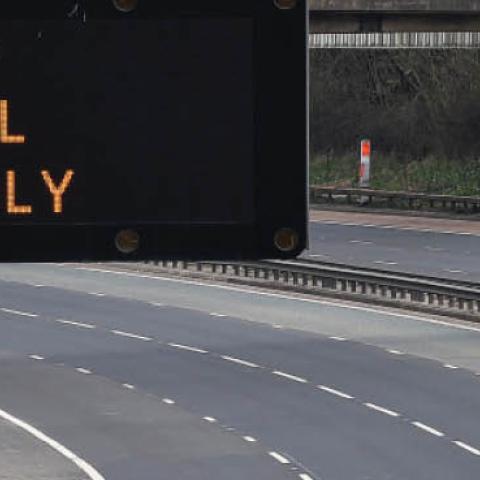 A motorway sign on the M8 motorway advising on essential travel only on March 24 in Glasgow, Scotland.