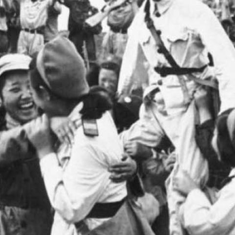 North Korean and Chinese troops celebrate a victory against U.S. forces in South Korea, c. June 25, 1950.