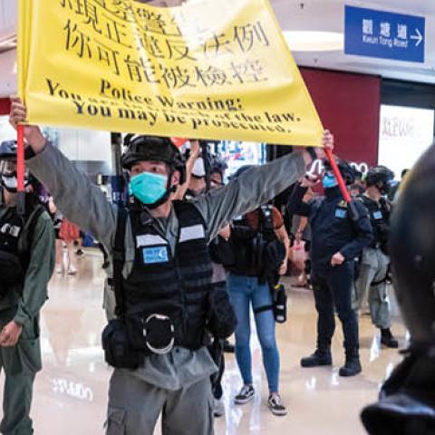 Riot police hold up a warning flag during a demonstration in a mall on July 6, 2020 in Hong Kong, China.