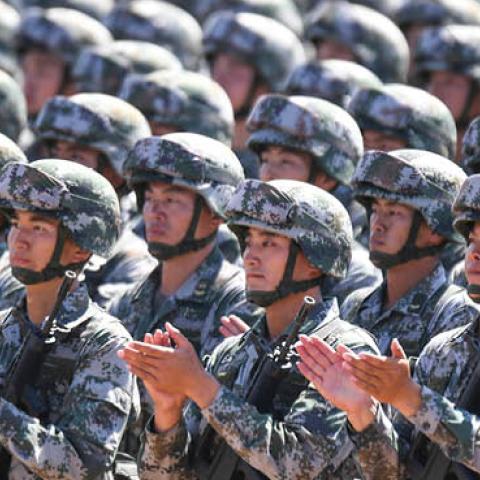 Chinese soldiers applaud during a military parade at the Zhurihe training base in China's northern Inner Mongolia region on July 30, 2017