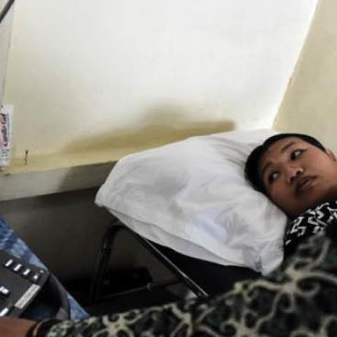 A doctor performs an ultrasound on a pregnant woman in Sukadana, Indonesia, Aug. 3, 2016.