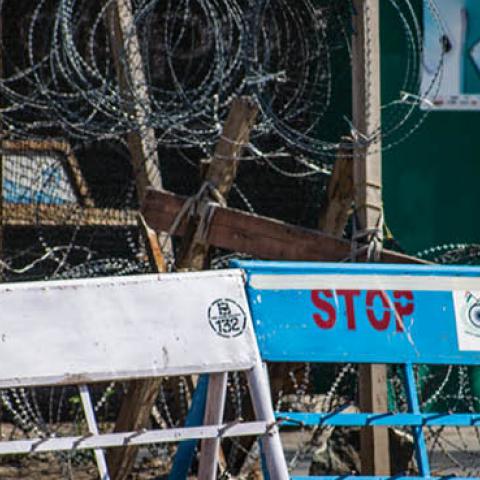 An Indian paramilitary trooper stands guard in front of his bunker in the deserted city square during a curfew like restrictions, a year after India revoked the special status of Jammu and Kashmir, in the city center on August 05, 2020