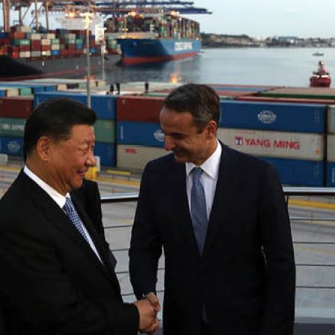 President of the Republic of China Xi Jinping (L) and Greek Prime Minister Kyriakos Mitsotakis (R) shake hands as they visit the cargo terminal of Chinese company Cosco in the port of Piraeus, Greece, on November 11, 2019, as part of his two-day official 