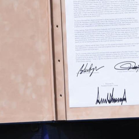 Israeli Prime Minister Benjamin Netanyahu holds up the document after participating in the signing of the Abraham Accords where the countries of Bahrain and the United Arab Emirates recognize Israel, at the White House on Sept. 15, 2020