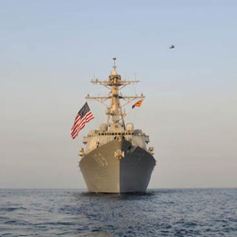SH-60B Sea Hawk helicopter and helicopters from US Army 35th Combat Aviation Brigade fly in formation over guided-missile destroyer USS Jason Dunham (DDG 109) after US Army-Navy interoperability training.