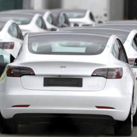 A worker exits a Tesla Model 3 electric vehicle at Tesla’s primary vehicle factory n Fremont, Calif., May 11, 2020.