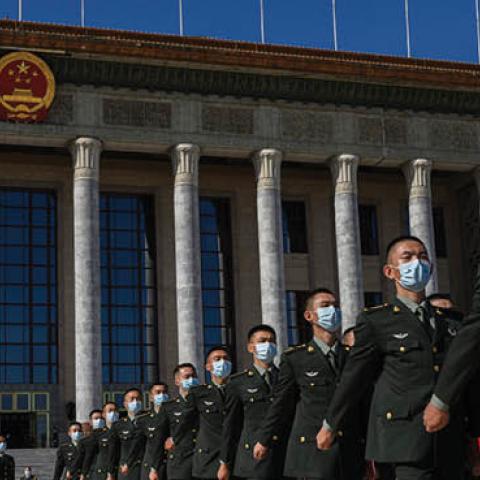 Chinese soldiers from the People's Liberation Army wear protective masks as they march after a ceremony marking the 70th anniversary of China's entry into the Korean War, on October 23, 2020 at the Great Hall of the People in Beijing, China.