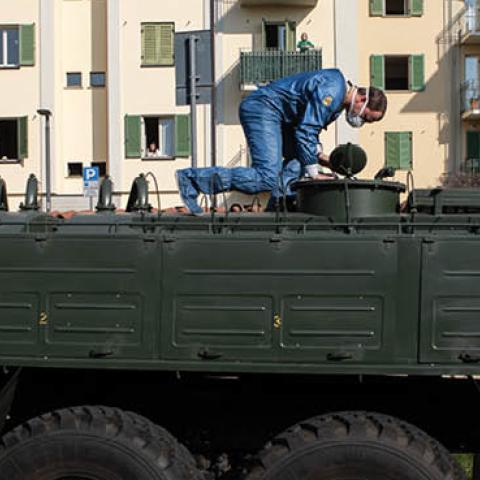 A Russian Army officer controls a manhole over a truck at Istituto Palazzolo nursing home on April 09, 2020 in Torre Boldone, Italy