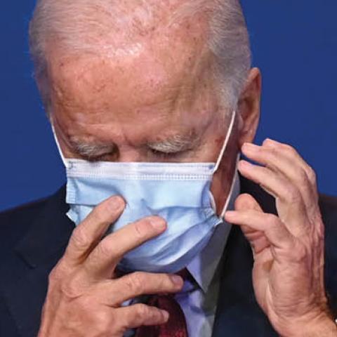 Democratic presidential candidate Joe Biden adjusts his facemask as he speaks on healthcare at The Queen in Wilmington, Delaware, on October 28, 2020. 