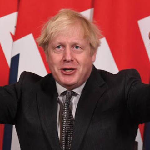 U.K. Prime Minister Boris Johnson celebrates after signing the Brexit trade deal in London, Dec. 30, 2020.
