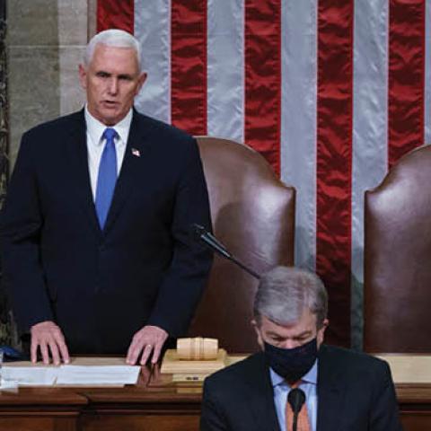 Vice President Mike Pence and Speaker of the House Nancy Pelosi, D-Calif., read the final certification of Electoral College votes cast in November's presidential election during a joint session of Congress, after working through the night, at the Capitol