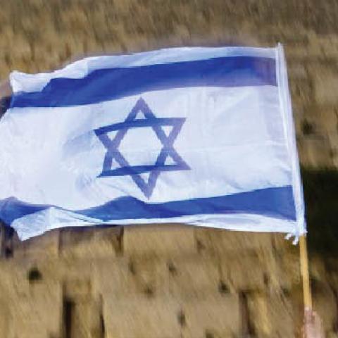 An Israeli waves a flag during a parade marking Jerusalem Day at the Western Wall in 2009.