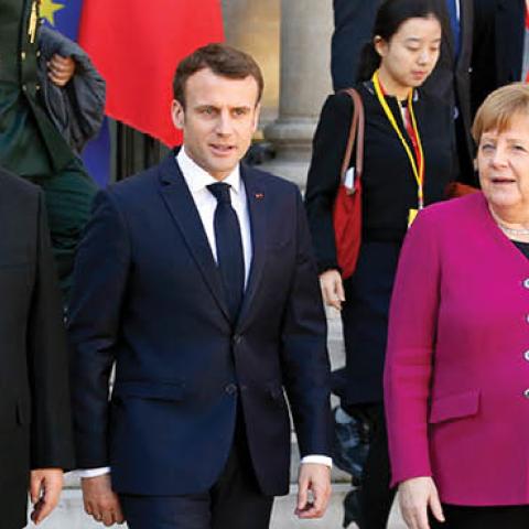 French President Emmanuel Macron accompanies Chinese President Xi Jinping and German Chancellor Angela Merkel after their meeting at the Élysée Presidential Palace on March 26, 2019 in Paris, France.