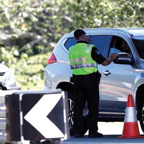 Police officer speaks to a motorists who is entering Queensland from New South Wales through the border checkpoint on December 21, 2020 in Coolangatta, Gold Coast, Australia
