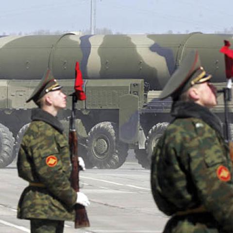 Russian soldiers stand near a Topol-M ICBM while participating in a rehearsal for the nation's Victory Day parade outside Moscow in Alabino on April 22, 2008.