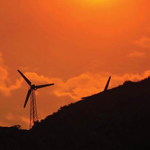Wind power generators are enveloped in a smoky sky near the Millard fire on July 15, 2006 near Cabazon, California.