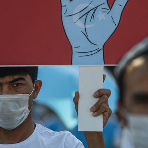 Supporters of China's Muslim Uighur minority wave flags of East Turkestan and hold placards as they gather at the Beyazid square on October 1, 2020 during a demonstration to protest China's Uighur treatment in Istanbul. (Photo by OZAN KOSE/AFP via Getty I