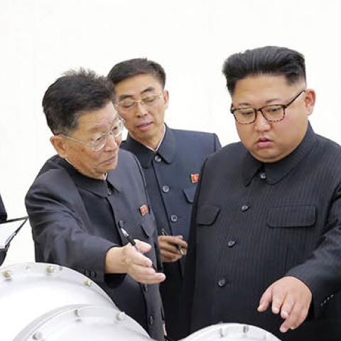 This undated picture released by North Korea's official Korean Central News Agency (KCNA) on September 3, 2017 shows North Korean leader Kim Jong-Un (C) looking at a metal casing with two bulges at an undisclosed location. (STR/AFP via Getty Images)