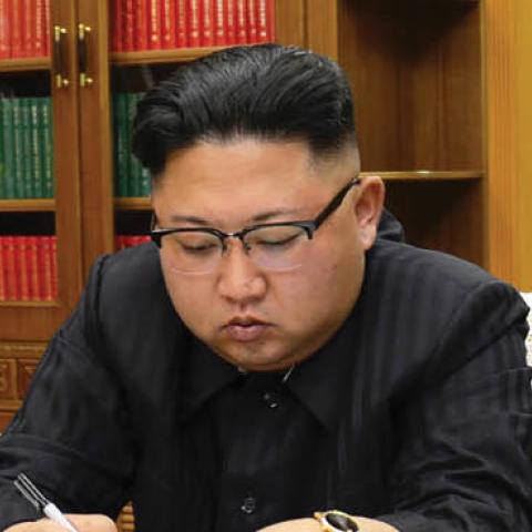 North Korean leader Kim Jong-Un signing the order to carry out the test-fire of the intercontinental ballistic missile Hwasong-14 at an undisclosed location (STR/AFP via Getty Images)