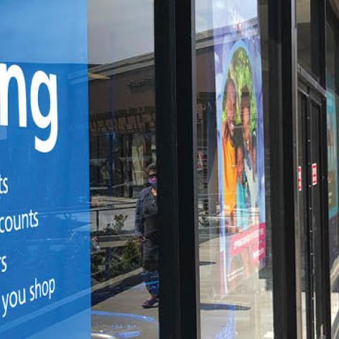 A pedestrian walks by a now hiring sign at Ross Dress For Less store on April 02, 2021 in San Rafael, California (Photo by Justin Sullivan/Getty Images)