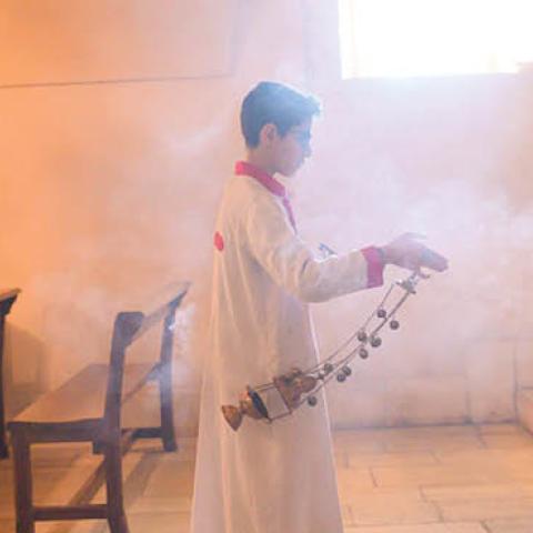 In this photograph taken on February 23, 2020, a young member of the Assyrian Christian community walks with insense during a Sunday mass at the More Benham Kirklar Church in Mardin, south-eastern Turkey (Photo by BULENT KILIC/AFP via Getty Images)