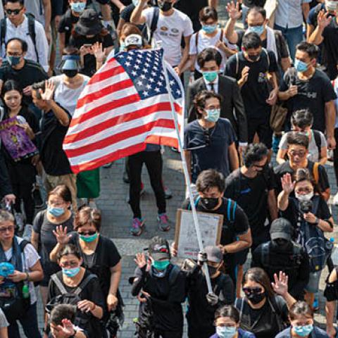 A Protester is seen holding up a US Flag in Hong Kong on September 8, 2019, Protester march from Charter Garden to the US Consulate in Hong Kong calling for support. (Photo by Vernon Yuen via Getty Images)