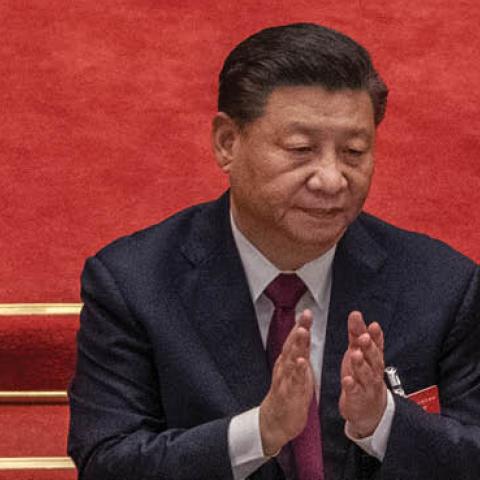 China's President Xi Jinping applauds after voting during a session during the closing session of the National People's Congress (Photo by Kevin Frayer/Getty Images).