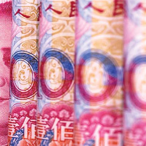 Chinese RMB banknotes are arranged for a photograph (Photo by Zhang Peng/LightRocket via Getty Images)