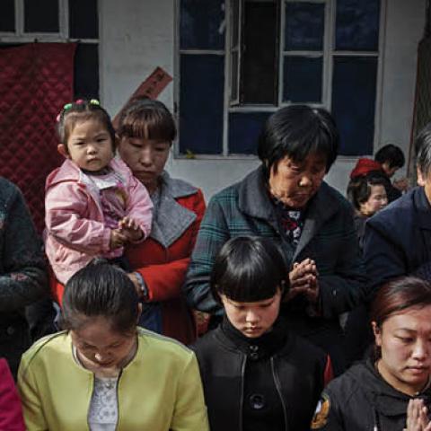 Chinese Catholic worshippers wait to take communion at the Palm Sunday Mass during the Easter Holy Week at an "underground" or "unofficial" church on April 9, 2017 near Shijiazhuang, Hebei Province, China (Photo by Kevin Frayer/Getty Images)