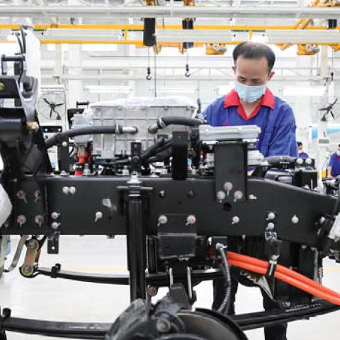 Employees work on production line at a new factory of China's leading new energy vehicle (NEV) manufacturer BYD on July 6, 2020 in Huai'an, Jiangsu Province of China. (Photo by Zhao Qirui/VCG via Getty Images)