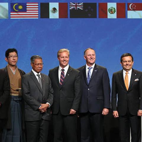 New Zealand Prime Minister John Key (6R) and Ministerial Representatives from 12 countries pose for a photo after signing the Trans-Pacific Partnership agreement in Auckland on February 4, 2016 (MICHAEL BRADLEY/AFP via Getty Images)
