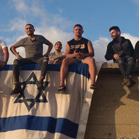 Israelis gather to watch the Iron Dome missile defence system launch to intercept rockets fire from the Gaza Strip on May 17, 2021 in Ashdod, Israel (Photo by Amir Levy/Getty Images)