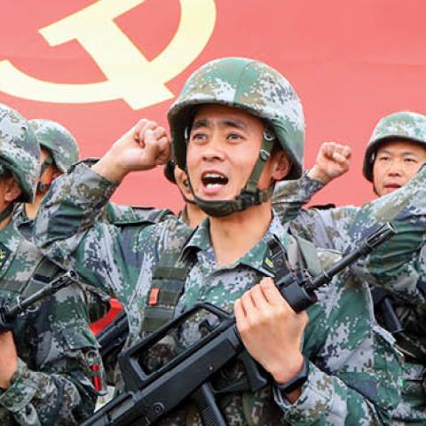 Members of the Communist Party of China (CPC) review the oath of joining the party in front of the party flag on April 13, 2021 in Luoyang, Henan Province of China. (Photo by Jia Fangwen/VCG via Getty Images)