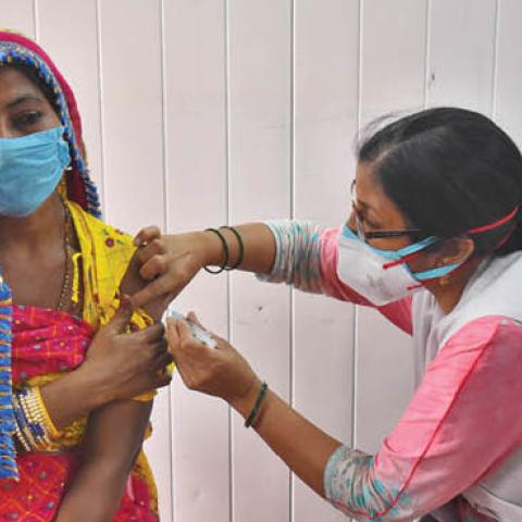 A resident of the street artists transit camp is inoculated against Covid-19 at Anand Parbat on May 10, 2021 in New Delhi, India. (Photo by Raj K Raj/Hindustan Times via Getty Images)