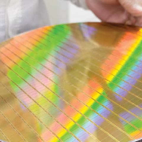 A researcher displays a silicon wafer, an essential material used in the production of semiconductors and other technologies critical to US national security. (Getty Images)