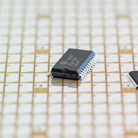A new type of 300 millimeter wafer with semiconductor chips and finished microchips of the semiconductor German manufacturer Bosch are seen in Dresden, eastern Germany on May 31, 2021 (Photo by JENS SCHLUETER/AFP via Getty Images)