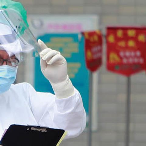 A medical worker wearing a PPE at Far Eastern Hospital triage patients who are receiving a Covid PCR test following a worsen local outbreak of COVID-19, in Taipei, Taiwan (Photo by Ceng Shou Yi/NurPhoto via Getty Images)