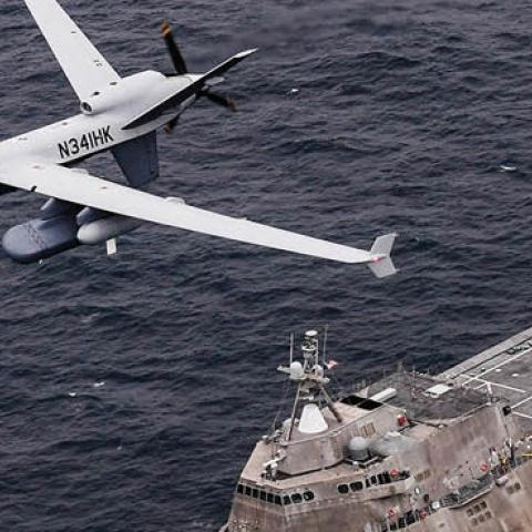 Caption: An MQ-9 Sea Guardian unmanned maritime surveillance aircraft system flies over Independence-variant littoral combat ship USS Coronado. (U.S. Navy)