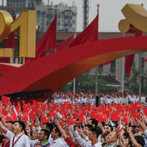 Members of the audience stand and applaud  Xi Jinping during his speech at a ceremony marking the 100th anniversary of the Communist Party at Tiananmen Square on July 1, 2021 (Photo by Kevin Frayer/Getty Images)