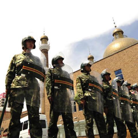 Chinese paramilitary police guard the outside of the Grand Bazaar in the Uighur area in the city of Urumqi in China's Xinjiang region on July 12, 2009 (PETER PARKS/AFP via Getty Images)