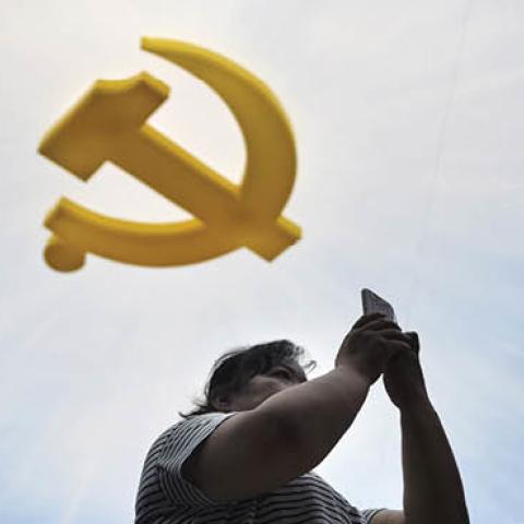 A visitor uses her phone at the Chinese Military Museum in Beijing. (Wang Zhao/AFP via Getty Images)