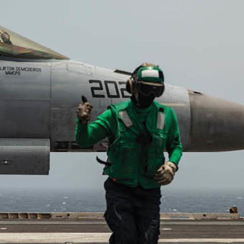 Sailors signal that an F/A-18E Super Hornet fighter jet is ready for takeoff on the flight deck of aircraft carrier USS Ronald Reagan. (U.S. Navy)