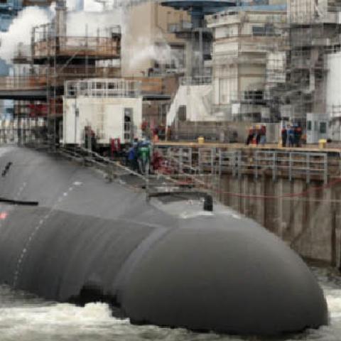 A submarine undergoes maintenance at the government-owned Norfolk Naval Shipyard. (Navy)