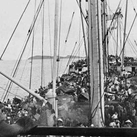An American soldier watches over South Vietnamese refugees on a U.S. Navy boat off the coast of Vietnam, May 5, 1975. (AGENCE FRANCE-PRESSE/GETTY IMAGES)