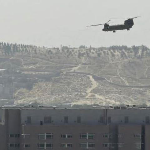 A U.S. Chinook military helicopter flies above the US embassy in Kabul on August 15, 2021. Several hundred employees of the US embassy in Kabul have been evacuated from Afghanistan, a US defense official said on August 15, 2021, as the Taliban entered the
