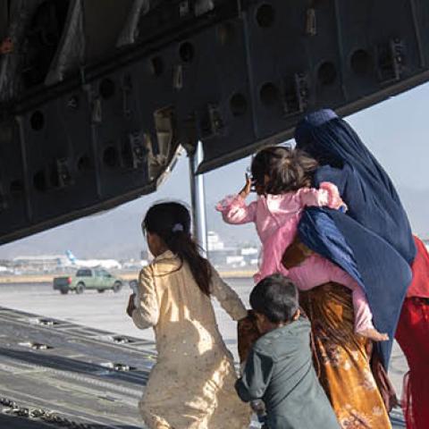 U.S. Air Force loadmasters and pilots load passengers aboard a U.S. Air Force C-17 Globemaster III (Photo by Master Sgt. Donald R. Allen/U.S. Air Forces Europe-Africa via Getty Images)