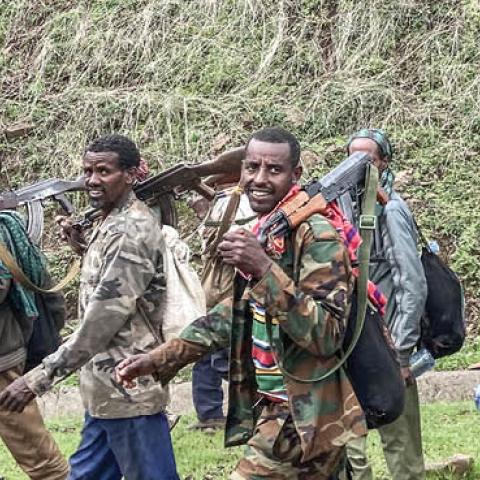 Members of the Amhara militia walk along the road in a rural area near the village of Adi Arkay, 180 kilometers northeast from the city of Gondar, Ethiopia, on July 14, 2021.