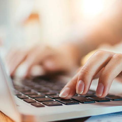A woman types on her laptop keyboard (Getty)