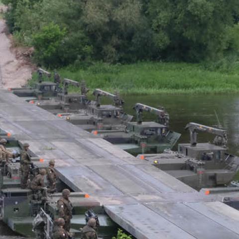 Battle Group Poland U.S., U.K and 15th Mechanized Brigade Polish tactical vehicles perform river crossing training June 19 in Rukla (U.S. Army photo by Spc. Kevin Wang/Released)