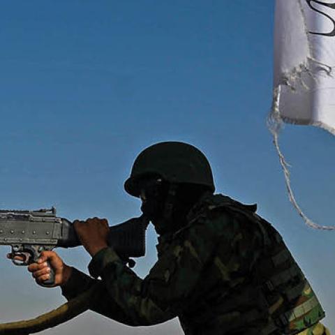 A Taliban fighter mans a machine gun mounted on a vehicle near the venue of an open-air pro-Taliban rally on the outskirts of Kabul on October 3, 2021 (Photo by HOSHANG HASHIMI/AFP via Getty Images)